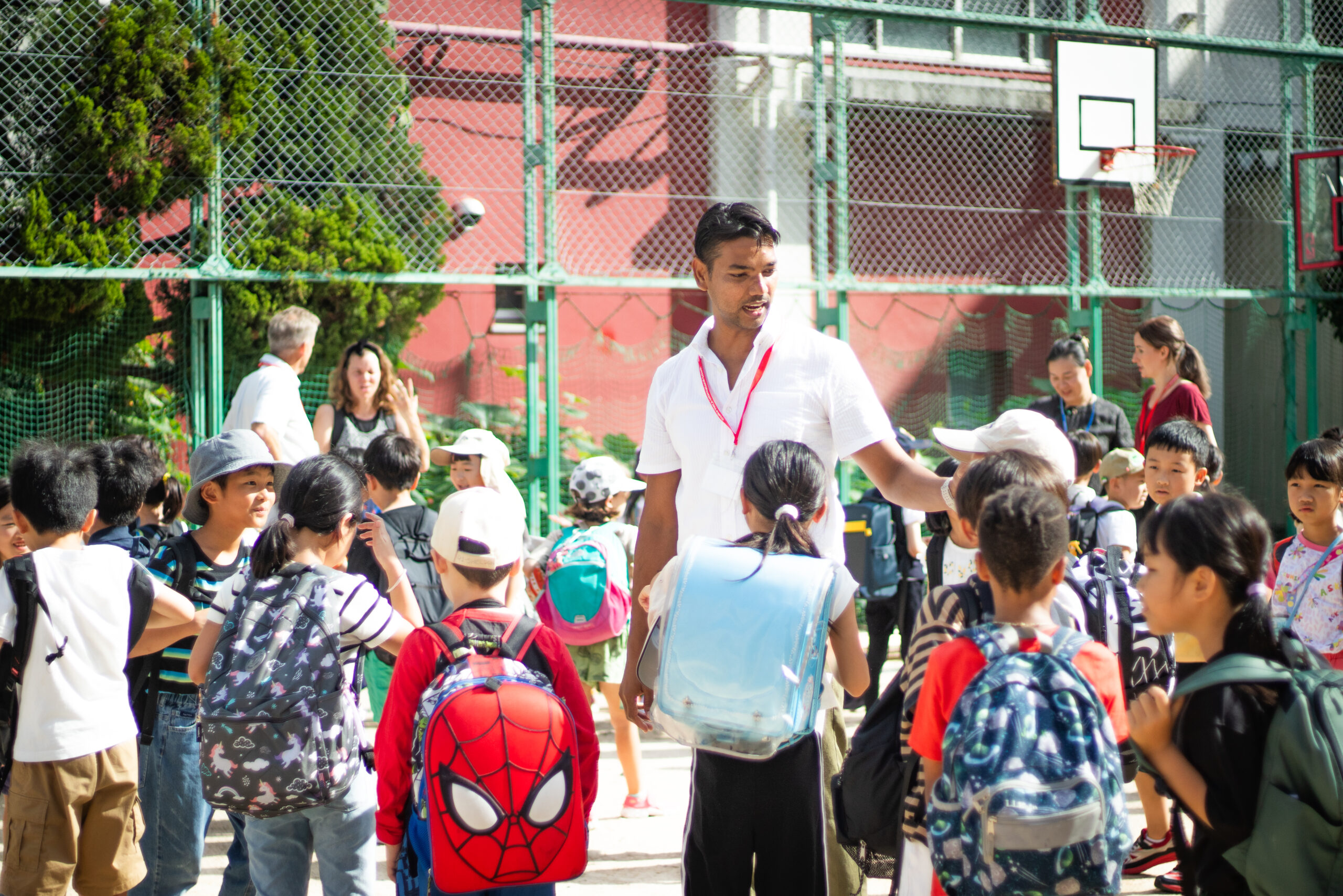 Teacher gathering students outside