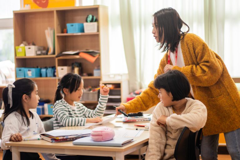 Teacher helping students in the classroom