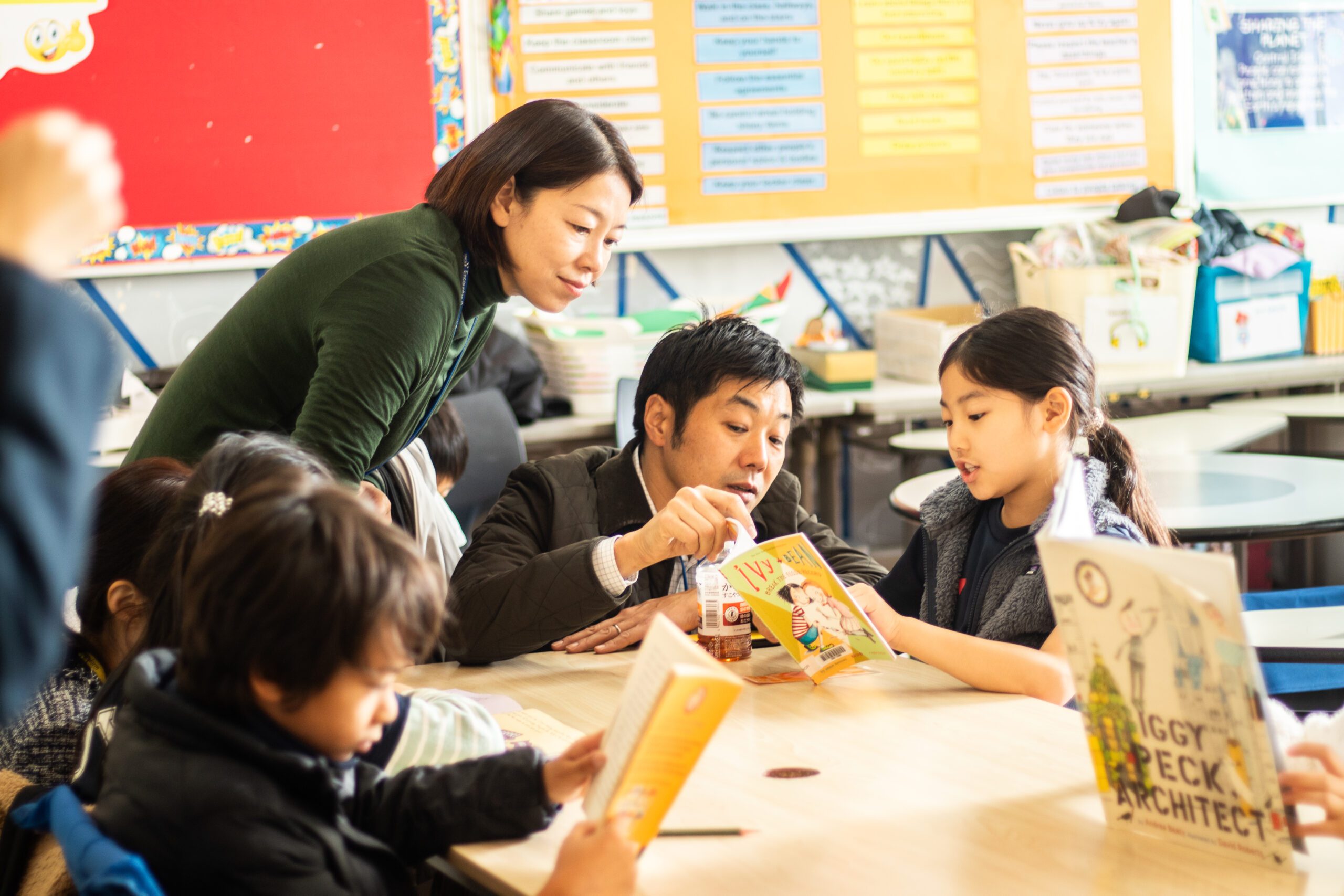 Parents reading with PYP students in the classroom