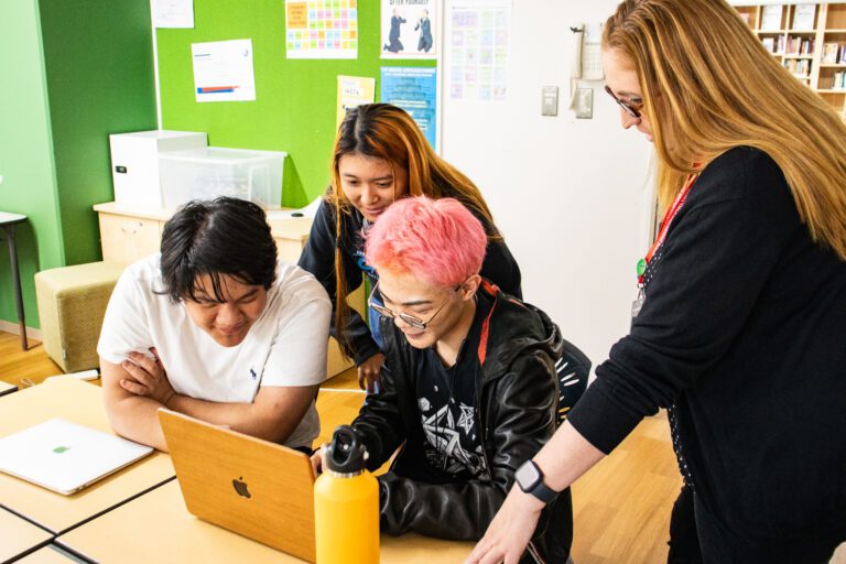 Teacher meeting with group of students
