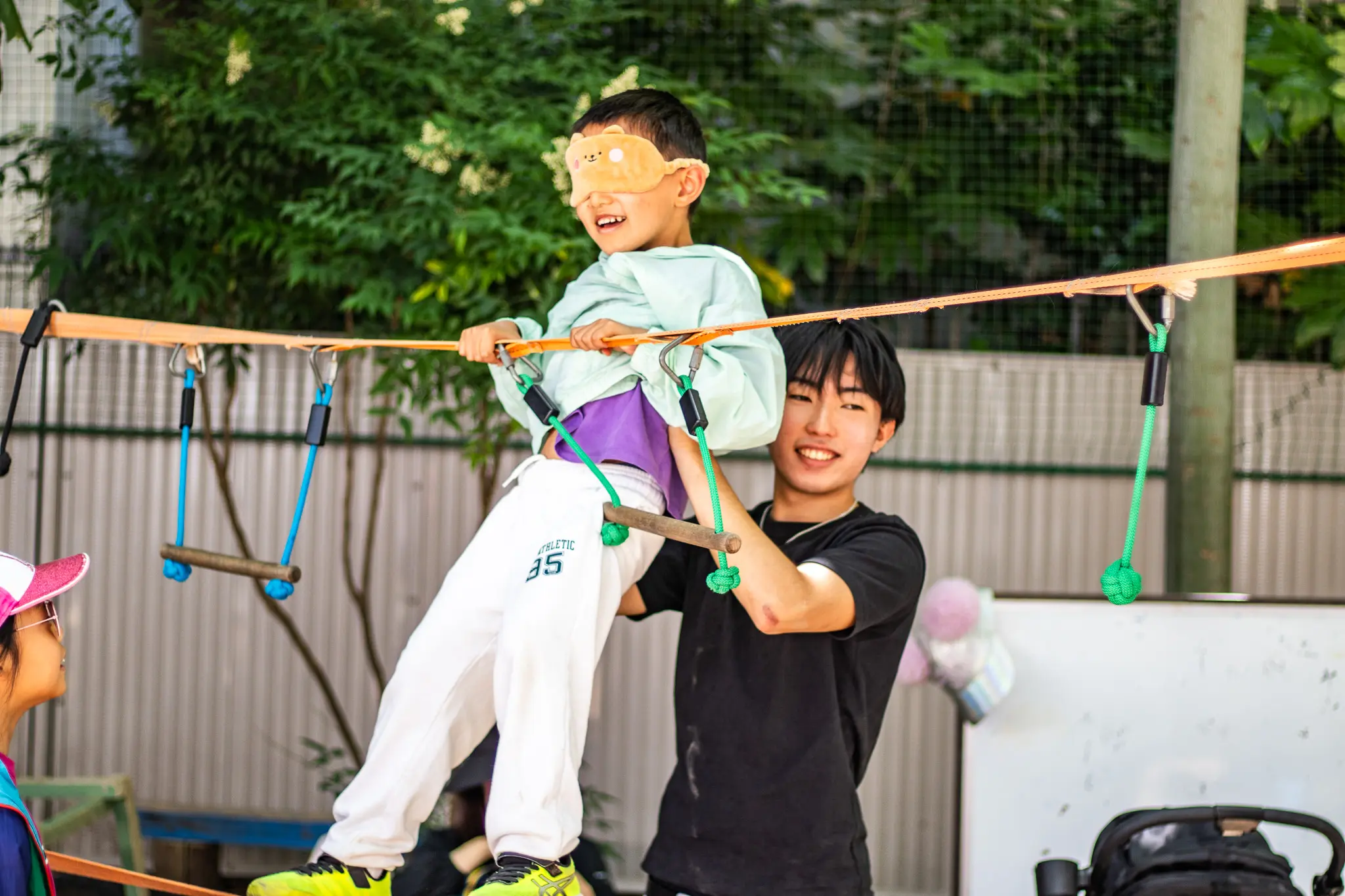 A DP student playing games with a PYP student